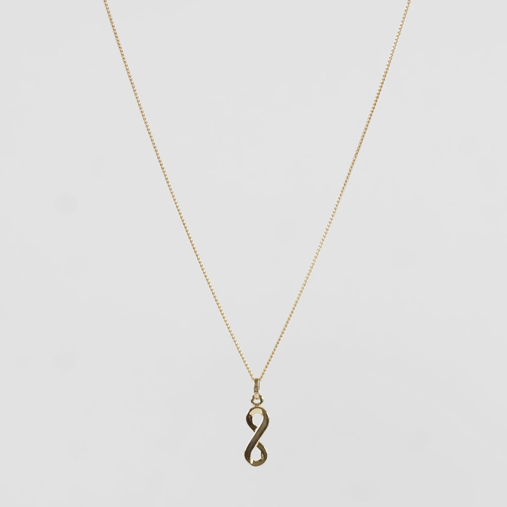 A stunningly beautiful infinity hoop-shaped Pure 18k Gold pendant adorning a Pure 18k Gold chain 